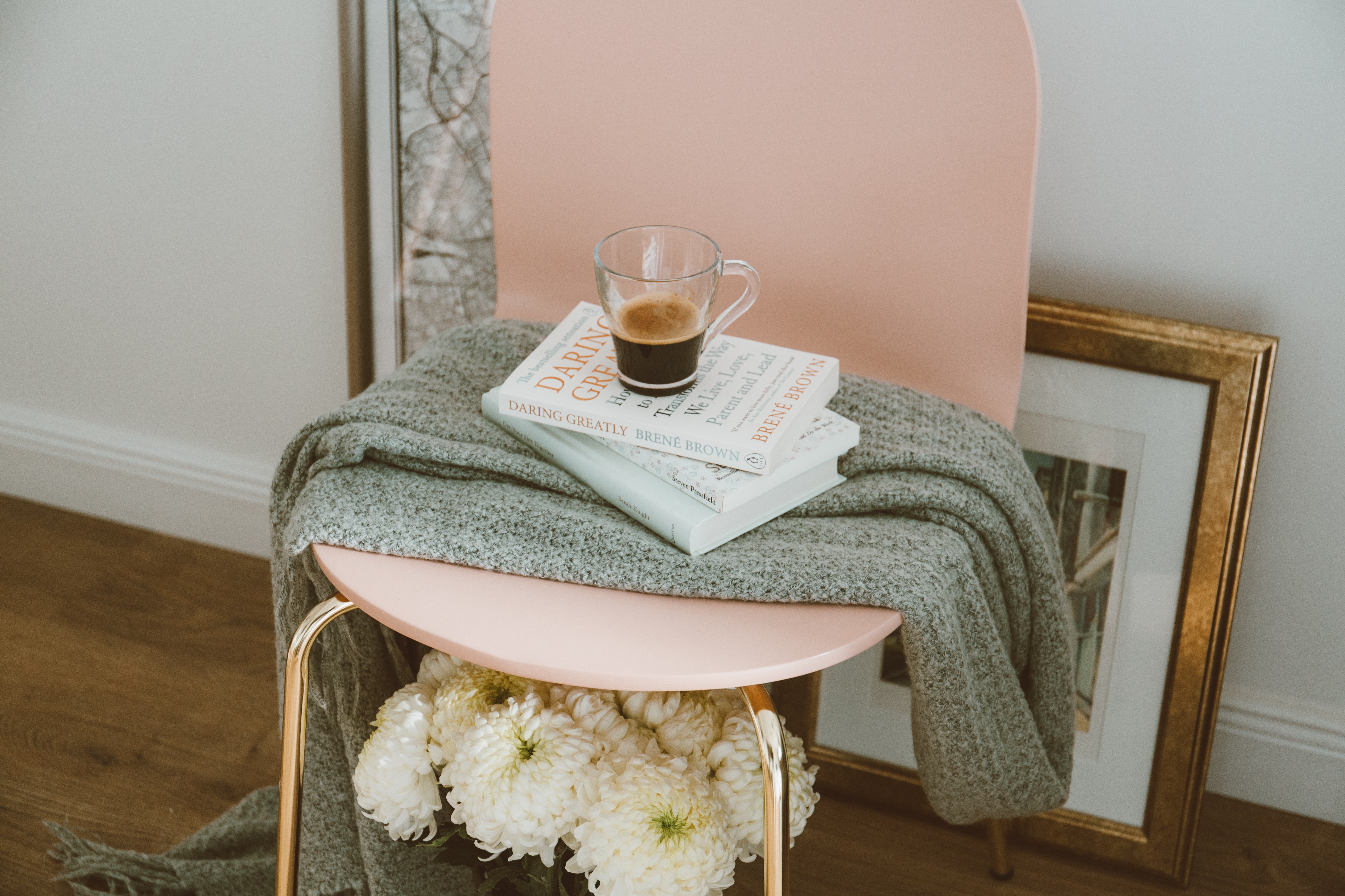 Pink chair with books and coffee cup